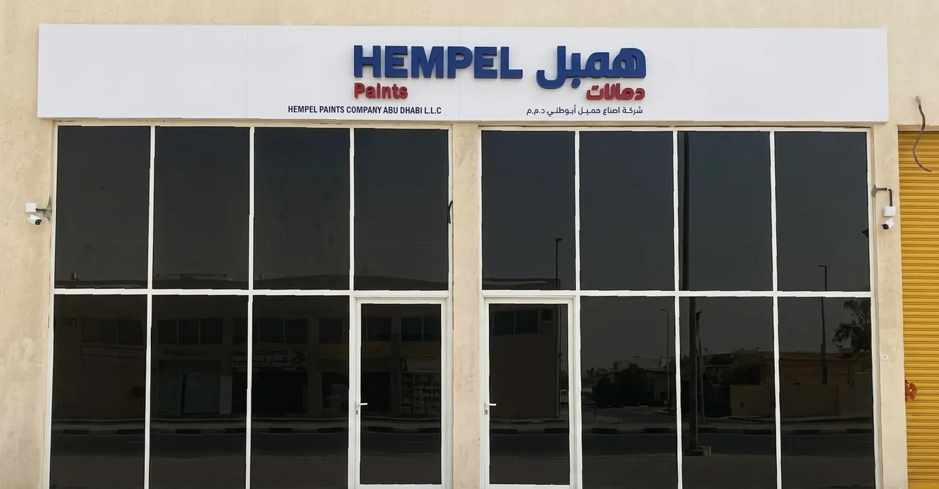 Hempel Paints branch shopfront with aluminium glazing and bilingual signage