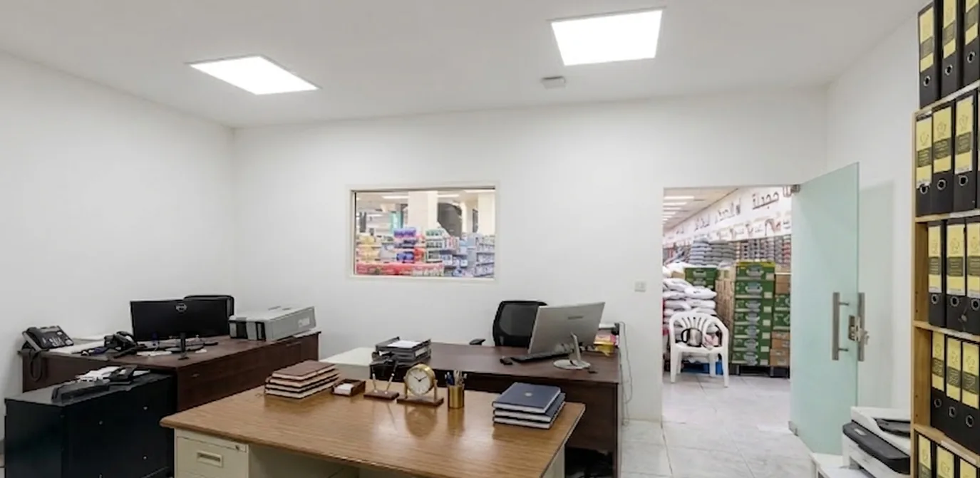 Commercial interior fit-out of a back-of-house office with LED panels and vision window